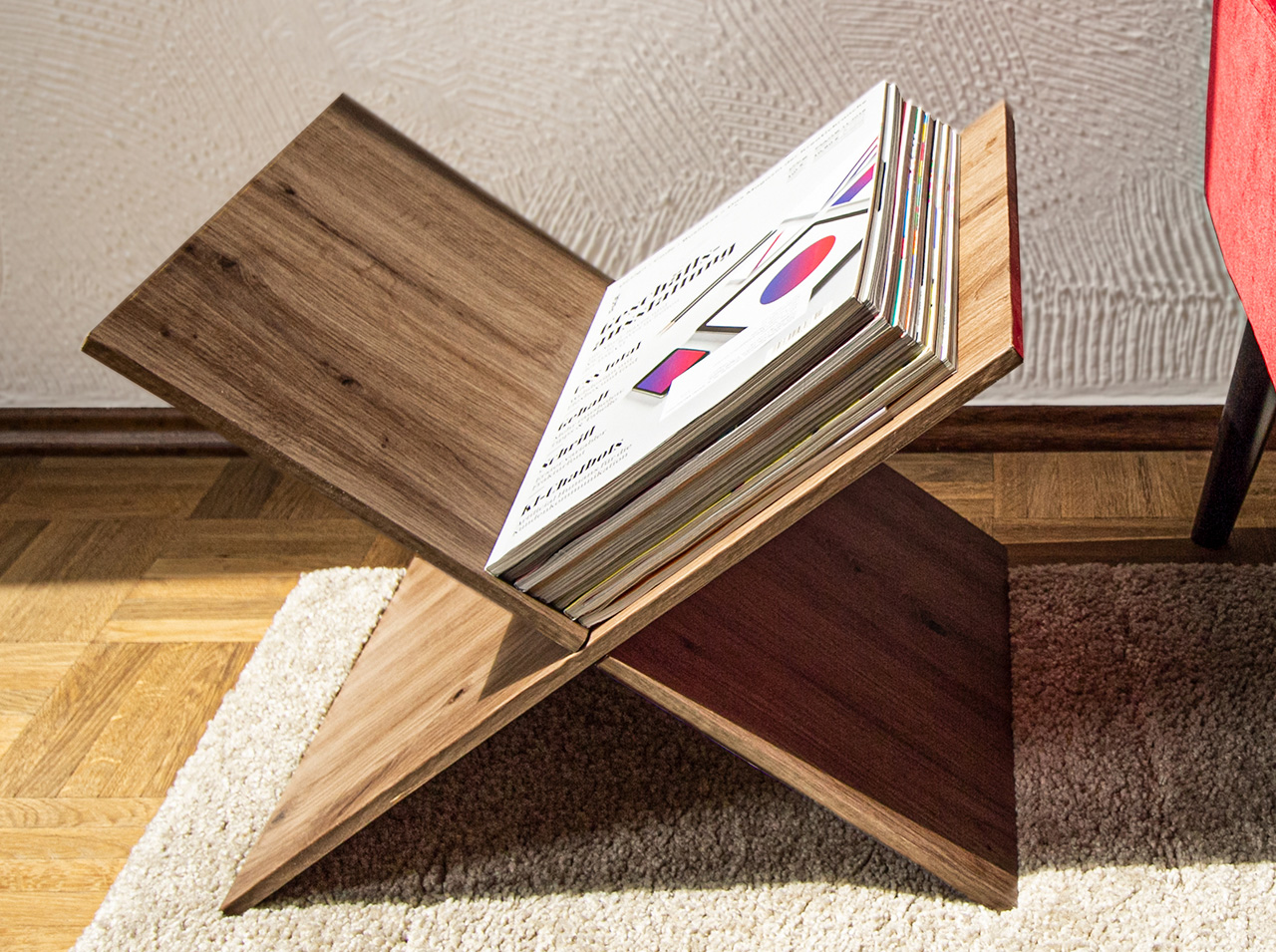DIY magazine rack made of two wooden boards covered in d-c-fix® Artisan Oak adhesive foil and slotted together.