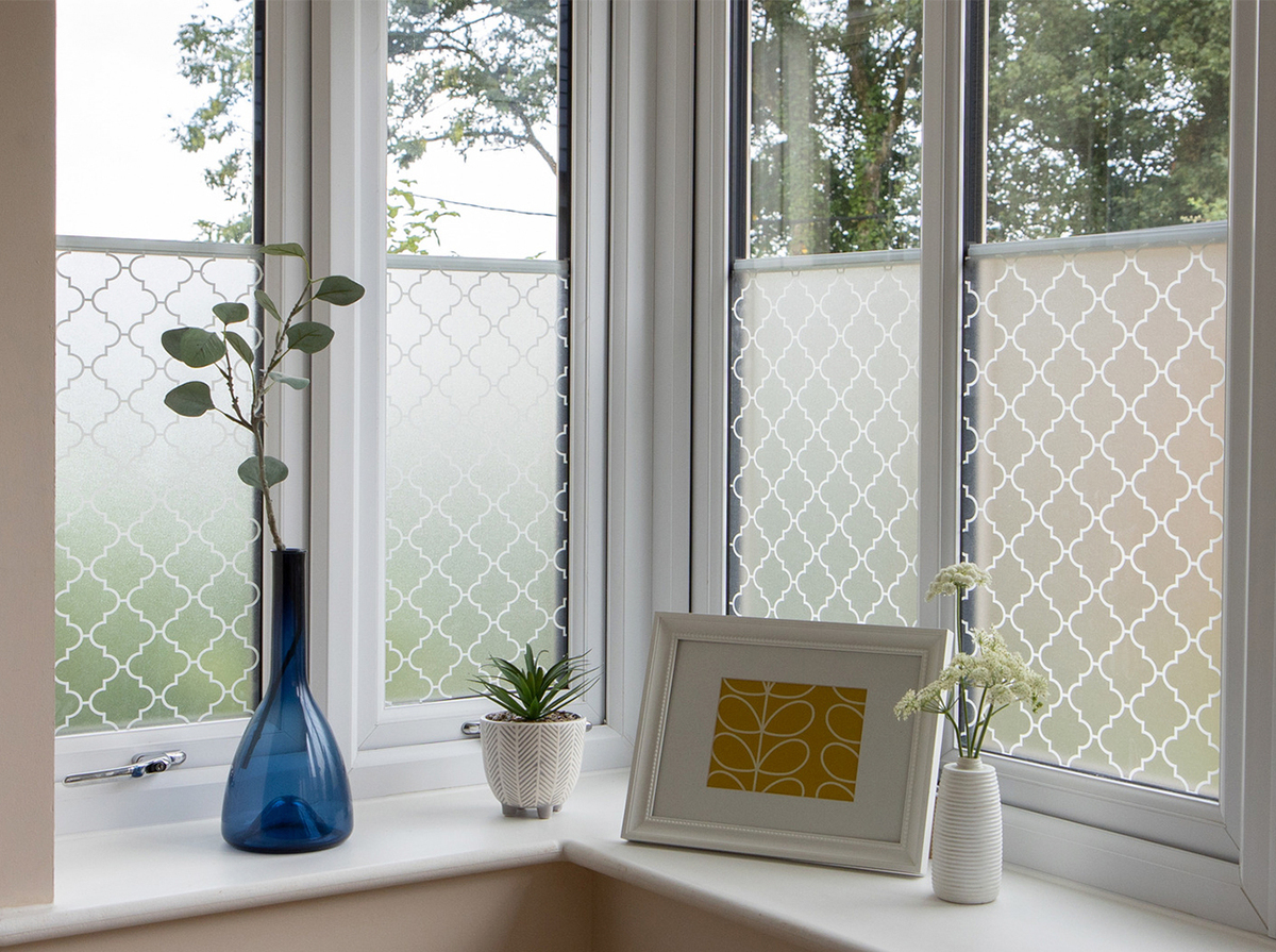 Window with d-c-fix® transparent Onadi window film covered in an ornamental pattern for privacy protection.