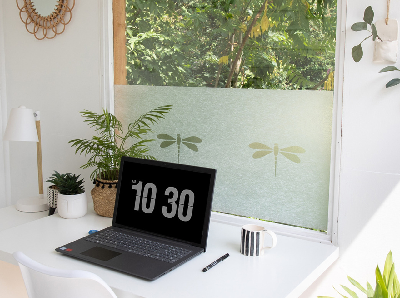 Window in the home office with the opaque d-c-fix® Nibella privacy film in a dragonfly design.