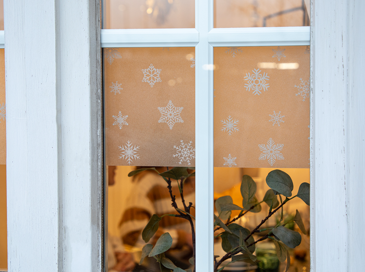 Window with privacy border in a snowflake design.